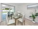 Bright dining area with views of the pool and access to the outdoors at 6920 13Th N Ave, St Petersburg, FL 33710