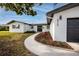 Landscaped front yard and walkway lead to the home's entrance, complemented by a manicured lawn at 6920 13Th N Ave, St Petersburg, FL 33710