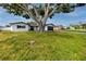 Well-maintained single-story house with a large front yard and a mature tree at 6920 13Th N Ave, St Petersburg, FL 33710