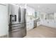 Beautiful kitchen with stainless steel appliances, modern white cabinets, and light wood floors at 6920 13Th N Ave, St Petersburg, FL 33710