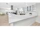 Open-concept kitchen with an oversized island, stainless steel appliances, and white cabinetry at 6920 13Th N Ave, St Petersburg, FL 33710