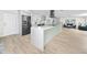Open floor plan with a kitchen island, stainless steel refrigerator, and a view of the living room at 6920 13Th N Ave, St Petersburg, FL 33710