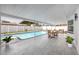 This covered pool area features outdoor seating and dining area at 6920 13Th N Ave, St Petersburg, FL 33710
