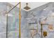 Beautiful marble shower with gold fixtures and rainfall shower head enhances this bathroom at 6920 13Th N Ave, St Petersburg, FL 33710