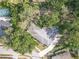Captivating aerial view of a home nestled among lush trees, showcasing its roof, and expansive surrounding greenery at 7002 Doreen St, Tampa, FL 33617