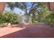 Backyard patio with a shed surrounded by lush trees and foliage at 7002 Doreen St, Tampa, FL 33617
