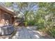 A pleasant backyard featuring stone pavers, an A/C unit, and lush vegetation at 7002 Doreen St, Tampa, FL 33617