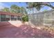 Exterior view of a brick home and shed in backyard, shaded by a large tree at 7002 Doreen St, Tampa, FL 33617