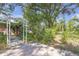 A lush backyard featuring stone pavers, green foliage, and an elegant garden archway at 7002 Doreen St, Tampa, FL 33617