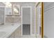 This bathroom features a dual sink vanity, tiled floors, and a mirrored sliding door closet at 7002 Doreen St, Tampa, FL 33617