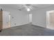 The spacious bedroom has white walls, carpet, and adjoins an ensuite bathroom and walk-in closet at 7002 Doreen St, Tampa, FL 33617