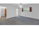 The spacious bedroom has white walls, carpet, and adjoins an ensuite bathroom and walk-in closet at 7002 Doreen St, Tampa, FL 33617