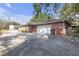 A long driveway with a two-car garage and a brick exterior, offering ample parking at 7002 Doreen St, Tampa, FL 33617