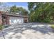 A long driveway with a two-car garage and a brick exterior, offering ample parking at 7002 Doreen St, Tampa, FL 33617