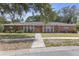 Sprawling brick ranch-style home with mature landscaping and a charming front entrance at 7002 Doreen St, Tampa, FL 33617