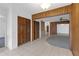 Hallway featuring tile flooring, wood paneling, and closet space at 7002 Doreen St, Tampa, FL 33617