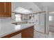 Functional kitchen with white appliances, light countertops, and ample cabinet space at 7002 Doreen St, Tampa, FL 33617