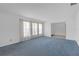 Bright living room with large windows, neutral walls, and a seamless transition to other rooms at 7002 Doreen St, Tampa, FL 33617