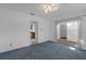 Cozy sunroom with classic carpeting, white walls, and a sliding glass door at 7002 Doreen St, Tampa, FL 33617