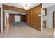 Spacious living room with wood paneling and views to other rooms of the home at 7002 Doreen St, Tampa, FL 33617