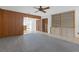 Open living room featuring carpet flooring, built-in shelving, and views to the kitchen at 7002 Doreen St, Tampa, FL 33617