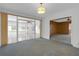 Living room with sliding glass doors and an entrance to another room at 7002 Doreen St, Tampa, FL 33617