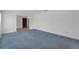 Inviting living room with neutral walls, neutral carpeting, and a view into the entryway at 7002 Doreen St, Tampa, FL 33617