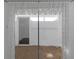 Enclosed patio with classic curtains, neutral walls, and small rocks on the floor at 7002 Doreen St, Tampa, FL 33617
