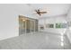 Bright sunroom featuring tile flooring, windows, and sliding glass doors at 7002 Doreen St, Tampa, FL 33617