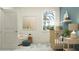 Bright Bedroom featuring a crib, comfortable chair, and serene decor elements at 7546 E 117Th Ln, Palmetto, FL 34221