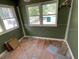 Small bedroom with twin windows, bare walls and floors at 7806 N Orleans Ave, Tampa, FL 33604