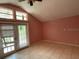 Bedroom area featuring vaulted ceilings and a french door entrance at 7806 N Orleans Ave, Tampa, FL 33604