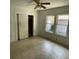 Bright bedroom featuring tile flooring, windows, and a closet at 7806 N Orleans Ave, Tampa, FL 33604