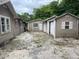 Backyard view with multiple sheds and an alley way at 7806 N Orleans Ave, Tampa, FL 33604