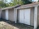 Exterior view of the garage, featuring double doors and supporting columns at 7806 N Orleans Ave, Tampa, FL 33604
