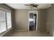 Bright living room featuring tile flooring and ceiling fan, flowing into kitchen area at 7806 N Orleans Ave, Tampa, FL 33604