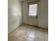 Tile-floored utility area with an exterior door and a window allowing natural light at 7806 N Orleans Ave, Tampa, FL 33604