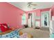 The bedroom has carpet floors, a ceiling fan, and a window for natural light at 8217 Canterbury Lake Blvd, Tampa, FL 33619