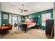 This bedroom features large windows, a ceiling fan, and carpet flooring at 8217 Canterbury Lake Blvd, Tampa, FL 33619