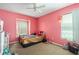 This bedroom offers carpet floors, a ceiling fan, and natural light from the window at 8217 Canterbury Lake Blvd, Tampa, FL 33619