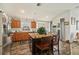 A kitchen island is surrounded by natural lighting from the sliding door and windows at 8217 Canterbury Lake Blvd, Tampa, FL 33619
