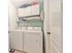 This functional laundry room has a washer, dryer, and storage shelves for organization at 8217 Canterbury Lake Blvd, Tampa, FL 33619