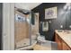 The tiled shower features a glass door and a small window, complemented by neutral tile flooring at 8217 Canterbury Lake Blvd, Tampa, FL 33619