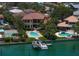 Wide aerial view of a waterfront property featuring a pool, dock, and landscaping along the water at 841 Ponce De Leon Dr, St Petersburg, FL 33715