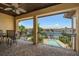 A covered balcony overlooking a beautiful canal view with a swimming pool and seating at 841 Ponce De Leon Dr, St Petersburg, FL 33715