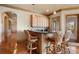 Open bar area featuring a granite counter and seating for four with hardwood floors and light wood cabinetry at 841 Ponce De Leon Dr, St Petersburg, FL 33715