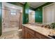 Beautiful bathroom featuring stylish green wallpaper, granite countertops, and a large vanity at 841 Ponce De Leon Dr, St Petersburg, FL 33715