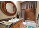 Well-appointed bathroom features a decorative framed mirror, granite countertop, and tile surround bathtub at 841 Ponce De Leon Dr, St Petersburg, FL 33715