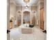 Luxurious bathroom with marble floors, dual showers, a soaking tub and custom cabinets at 841 Ponce De Leon Dr, St Petersburg, FL 33715