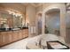 Luxurious bathroom featuring a soaking tub, dual shower, arched doorways, and vanity at 841 Ponce De Leon Dr, St Petersburg, FL 33715
